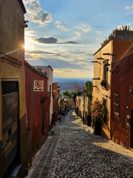 A cobblestone street in mexico with a view of the city photo