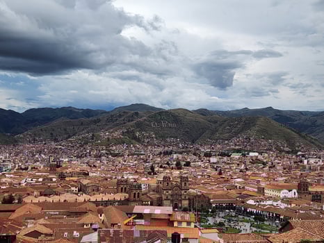 A city with many buildings and mountains in the background photo