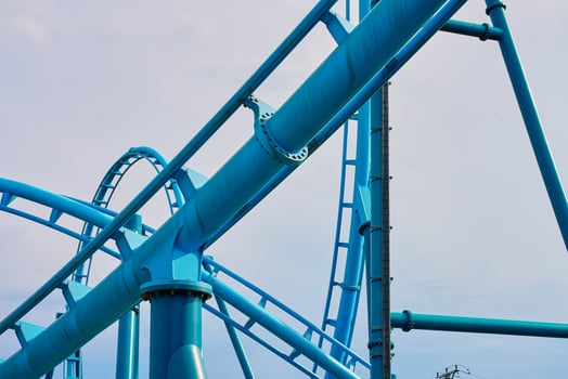 Roller coaster attraction in amusement park. Entertainment at summer holiday photo