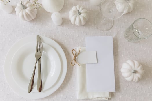 Thanksgiving table setting, tableware and decorations. Blank white postcard on table mockup. photo