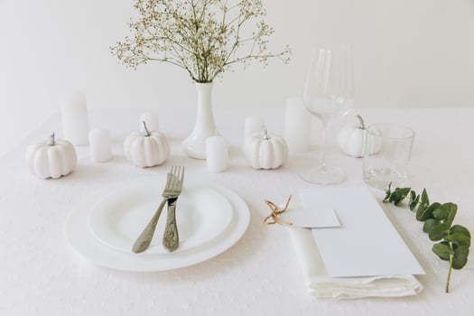 Thanksgiving table setting, tableware and decorations. Blank white postcard on table mockup. photo