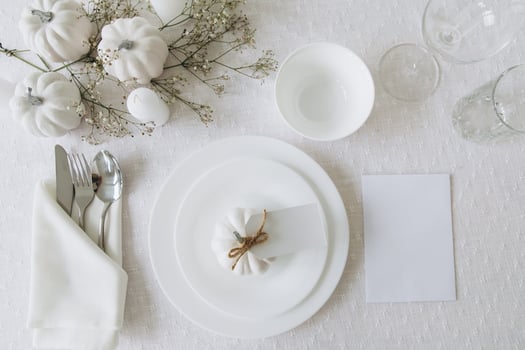 Thanksgiving table setting, tableware and decorations. Blank white postcard on table mockup, top view photo