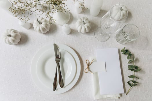 Thanksgiving table setting, tableware and decorations. Blank white postcard on table mockup, top view photo
