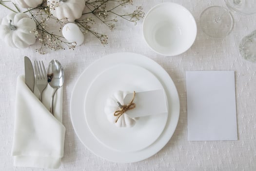 Thanksgiving table setting, tableware and decorations. Blank white postcard on table mockup, top view photo