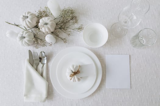 Thanksgiving table setting, tableware and decorations. Blank white postcard on table mockup, top view photo