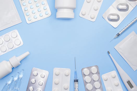 Medical supplies and pharmaceutical products arranged on a blue background. Copy space. Stock photo
