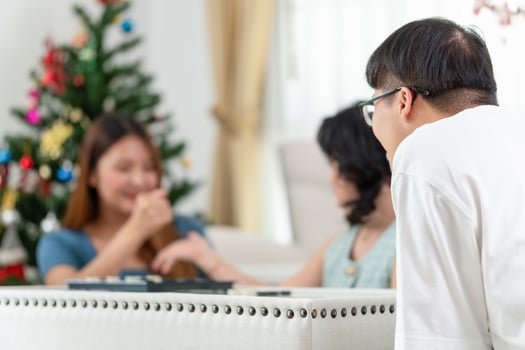 Asian man looking friends playing a game of checkers at home, Group of Asian friends enjoying at home photo