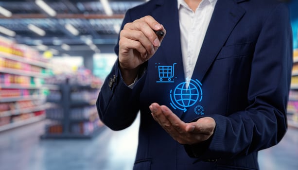 Man in business suit holding virtual shopping cart in supermarket photo