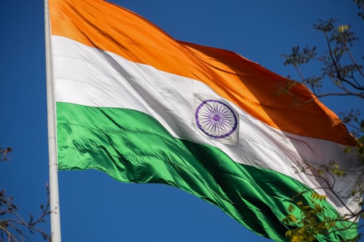 India flag flying high at Connaught Place with pride in blue sky, India flag fluttering, Indian Flag on Independence Day and Republic Day of India, tilt up shot, Waving Indian flag, Har Ghar Tiranga photo