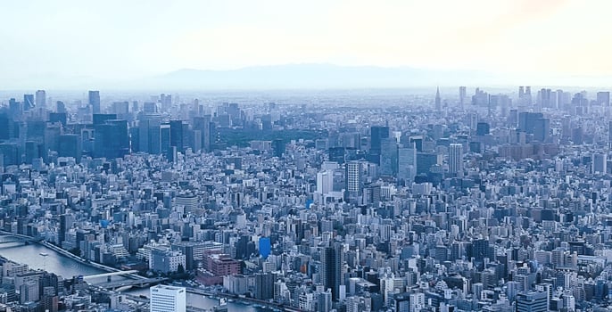 A cityscape with tall buildings and a river photo