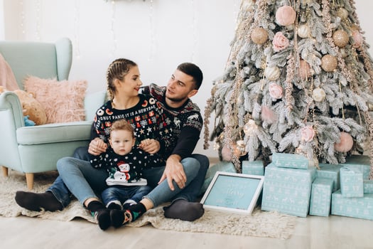 Portrait of happy family of father mother and little curly son celebrating Christmas together at home. photo