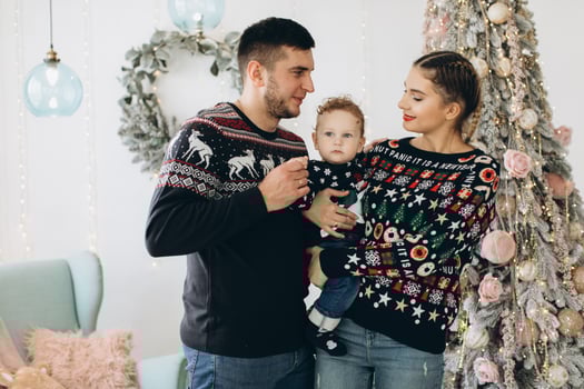 Portrait of happy family of father mother and little curly son celebrating Christmas together at home. photo