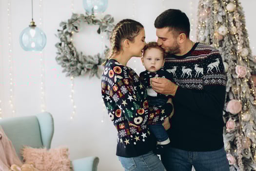 Portrait of happy family of father mother and little curly son celebrating Christmas together at home. photo