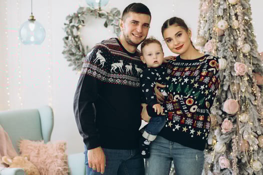 Portrait of happy family of father mother and little curly son celebrating Christmas together at home. photo