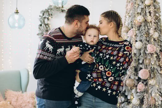 Portrait of happy family of father mother and little curly son celebrating Christmas together at home. photo