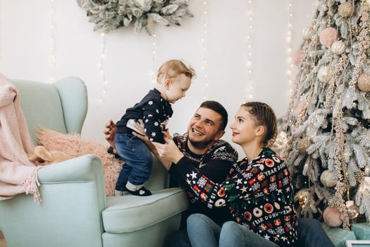 Portrait of happy family of father mother and little curly son celebrating Christmas together at home. photo