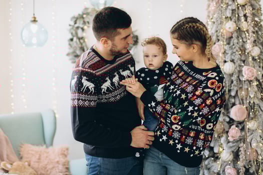 Portrait of happy family of father mother and little curly son celebrating Christmas together at home. photo