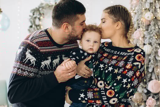 Portrait of happy family of father mother and little curly son celebrating Christmas together at home. photo