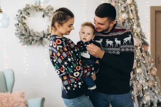 Portrait of happy family of father mother and little curly son celebrating Christmas together at home. photo