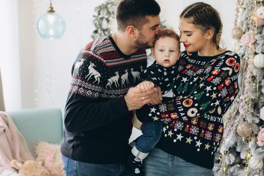 Portrait of happy family of father mother and little curly son celebrating Christmas together at home. photo