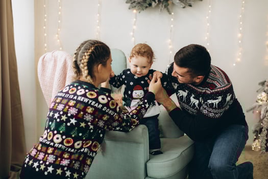 Portrait of happy family of father mother and little curly son celebrating Christmas together at home. photo
