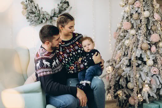 Portrait of happy family of father mother and little curly son celebrating Christmas together at home. photo