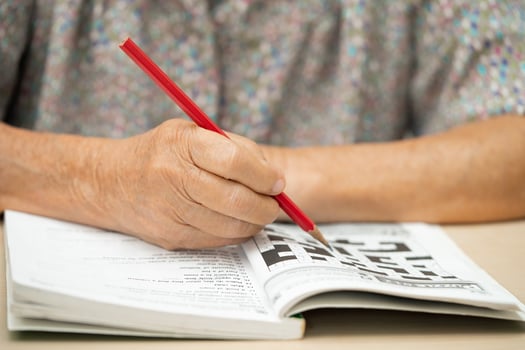 Alzheimer disease AD, Asian elderly woman playing sudoku puzzle game to practice for dementia prevention. photo