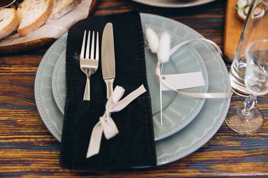 Close up of serving set, plate fork and knife decorated with decor on wooden table for your mockup photo