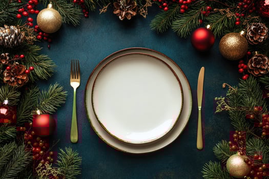Christmas table setting with empty plate surrounded by decorations photo