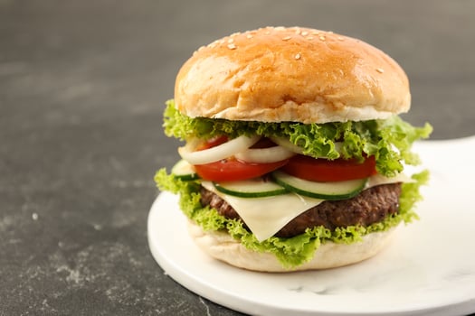 Close Up Homemade Hamburger with Beef Patty on White Ceramic Plate photo