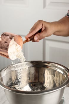 Baking Concept Pouring Flour to Stainless Mixing Bowl photo
