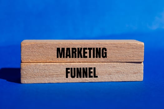 Marketing funnel message written on wooden blocks with blue background. Conceptual marketing funnel symbol. Copy space. photo