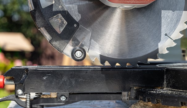 Miter saw, construction tool ,carpentry home renovation backgrounds, copy space image. Miter saw with a protective screen. Safe equipment for the furniture and construction industry. Close-up. photo