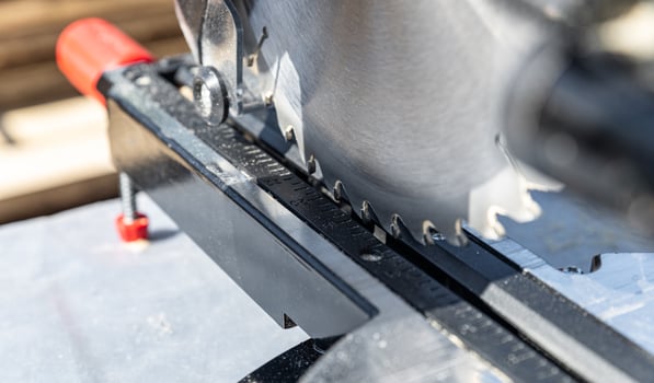 Close-up of industrial metal cutting tool. Sliding compound mitre saw or industrial saw in steel and metal production factory. Wood and sawing machine construction ideas concept. photo