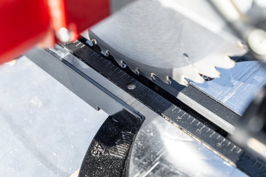 Close-up of industrial metal cutting tool. Sliding compound mitre saw or industrial saw in steel and metal production factory. Wood and sawing machine construction ideas concept. photo