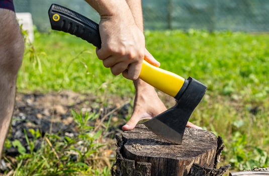 Steel axe, metal ax for wood chopping. Man holding heavy ax. Axe in lumberjack hands chopping or cutting wood trunks. photo