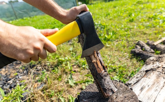 Steel axe, metal ax for wood chopping. Man holding heavy ax. Axe in lumberjack hands chopping or cutting wood trunks. photo