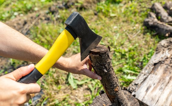 Steel axe, metal ax for wood chopping. Man holding heavy ax. Axe in lumberjack hands chopping or cutting wood trunks. photo