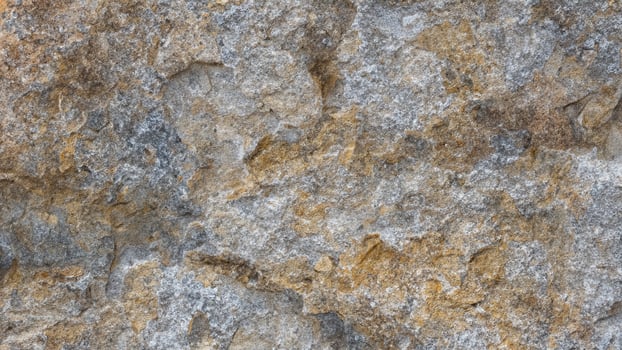 This rough-hewn rock face is a textured natural background. photo