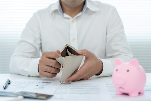 Stressed and headache asian man with large bills or invoices no money to pay to expenses and credit card debt. shortage, Financial problems, mortgage, loan, bankruptcy, bankrupt, poor, empty wallet photo
