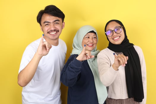 Three People Indonesain Family Showed Tinta Pemilu, Inked Finger after Voting for General ELection or Pilkada photo