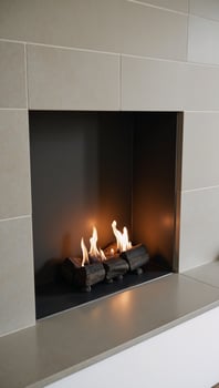 Modernstyle fireplace with a classic twist featuring beautifully lit fires amidst sleek tile surrounds photo