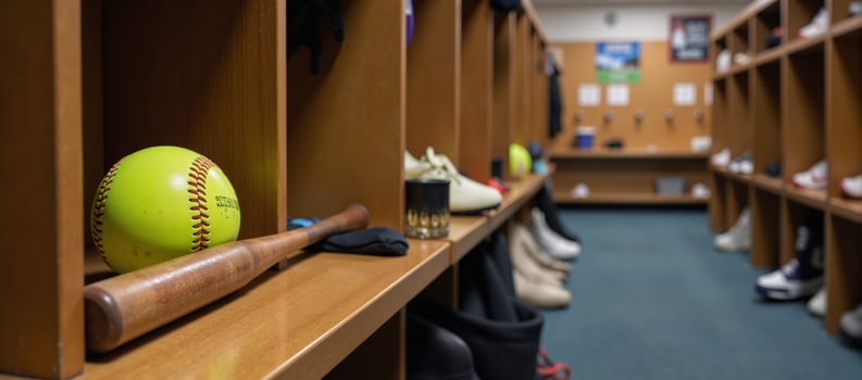 School locker room scene featuring baseball ball and bat among sports gear for athletic training photo