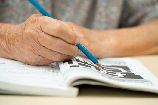 Alzheimer disease AD, Asian elderly woman playing sudoku puzzle game. photo