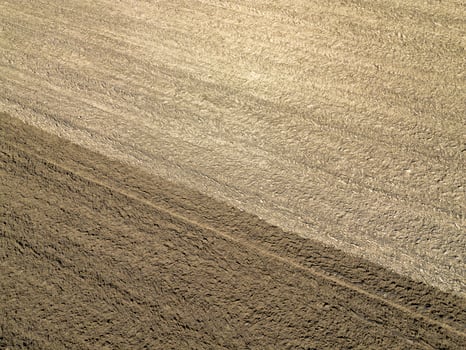 Plowed agricultural field, view from above, background. photo