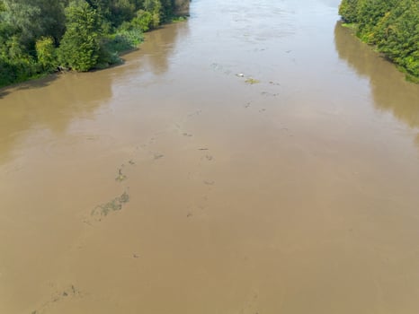 Mudflow of water in the Oder River of brown color. Poland. View from above. Background. photo
