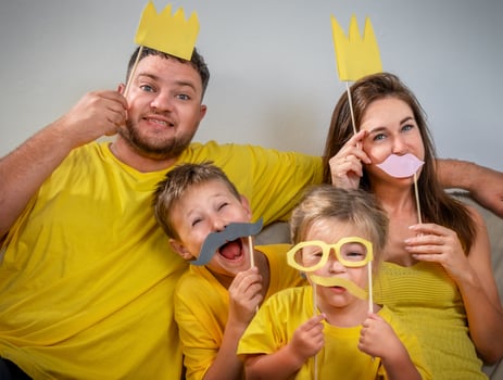 Funny family portrait with glasses, mustaches and crowns photo