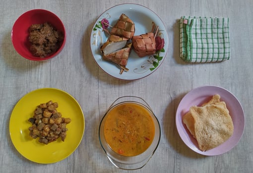 Variety of delicious Indonesian typical home cooked dishes served on the table on Eid al-Fitr from high angle view photo