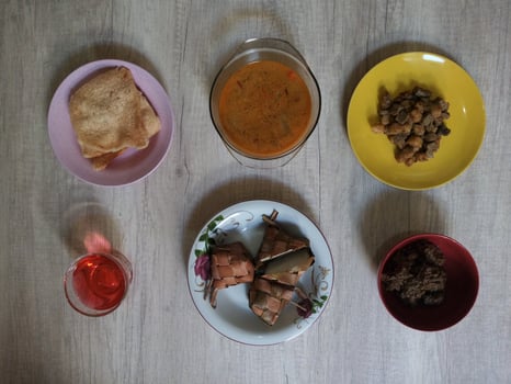 Variety of delicious Indonesian typical home cooked dishes served on the table on Eid al-Fitr from high angle view photo