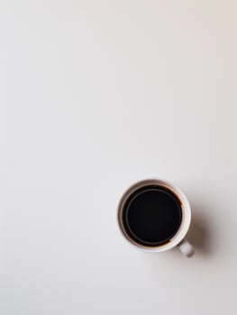 Photography with a white table, cup of coffee and free space. Minimalist neutral interior with concept of break and relaxation photo